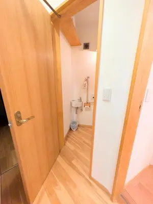 an open door to a bathroom with a toilet at Asukayama Forrest in Tokyo