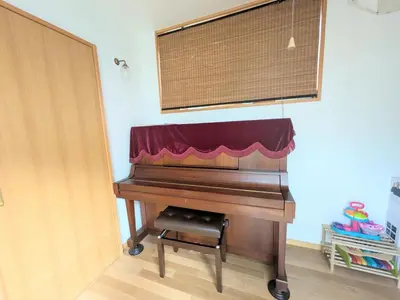 a piano sitting in a room with a window at Asukayama Forrest in Tokyo