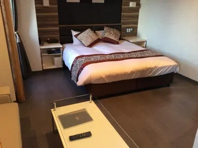 a hotel room with a bed and a scale at Amand Hotel in Tokyo