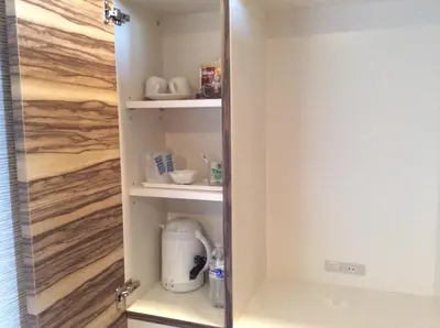 a cupboard with a coffee maker inside of it at Amand Hotel in Tokyo