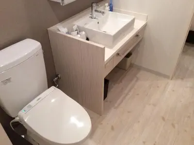a bathroom with a white toilet and a sink at Amand Hotel in Tokyo