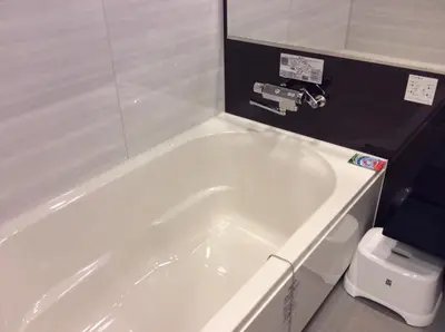 a white bath tub in a bathroom with a toilet at Amand Hotel in Tokyo