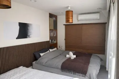 a bedroom with a bed with a teddy bear on it at Kei's House Kuramae Renovated Near Asakusa 7Guests in Tokyo