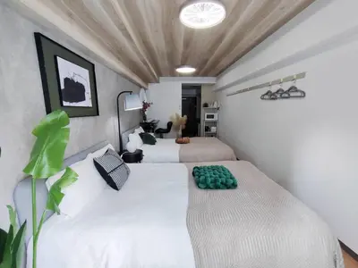 two beds in a room with white walls at X43\u65b0\u5bbf\u4e2d\u5fc3 \u8d85\u7ea7\u5546\u5708 \u4ea4\u901a\u67a2\u7ebd \u65b0\u5bbf\u8f66\u7ad98\u5206\u949f \u6700\u59274\u4eba Shinjuku center 8 mins to ST Max 4P \u76f4\u8fbe\u65b0\u5bbf \u6d89\u8c37 \u8868\u53c2\u9053 \u54c1\u5ddd \u6c60\u888b \u4e0a\u91ce \u4ee3\u4ee3\u6728 \u94f6\u5ea7 \u539f\u5bbf in Tokyo