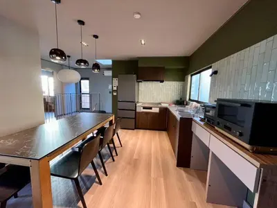 a large kitchen with a table and chairs in it at Rakuna Inn \u967d Sasazuka2 in Tokyo