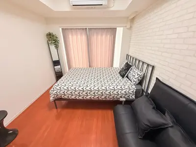 a bedroom with a bed and a couch at Shibuya center-350m from Shibuya station S9 in Tokyo