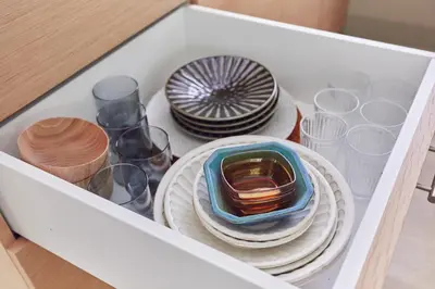 a drawer filled with glasses and plates and bowls at HATa in Tokyo