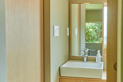 a bathroom with a sink and a mirror at HATa in Tokyo