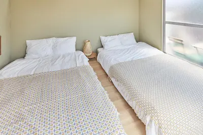 two beds sitting next to each other in a room at HATa in Tokyo