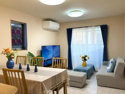 a living room with a table and a couch at Lapis House 201 - 2F in Tokyo
