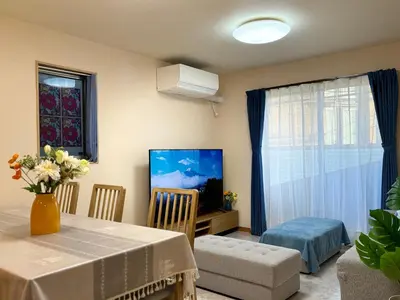 a living room with a dining table and a television at Lapis House 201 - 2F in Tokyo
