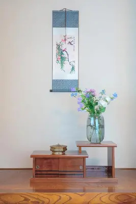 a vase of flowers sitting on top of a table at Shinjuku Skyview Serenity Duplex Villa in Tokyo