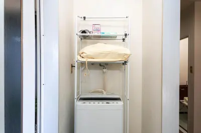 a laundry room with a washer and dryer at Shinjuku Skyview Serenity Duplex Villa in Tokyo