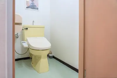 a bathroom with a yellow toilet in a room at Shinjuku Skyview Serenity Duplex Villa in Tokyo