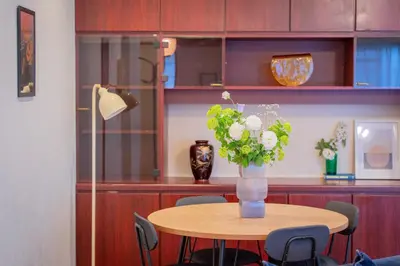 a table with a vase of flowers on it at Shinjuku Skyview Serenity Duplex Villa in Tokyo