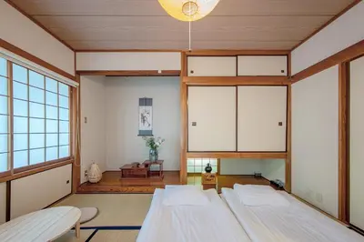 a room with two beds and a large window at Shinjuku Skyview Serenity Duplex Villa in Tokyo