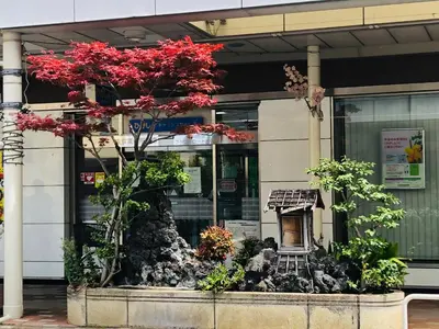 a tree with red leaves in front of a building at Lapis House 201 - 3F in Tokyo