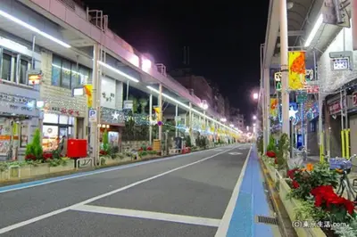 an empty city street at night with lights at Lapis House 201 - 3F in Tokyo