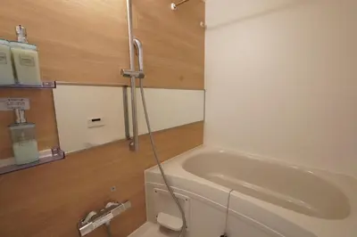 a bathroom with a bath tub and a sink at MUSASHI Residence Morisita Station Front in Tokyo