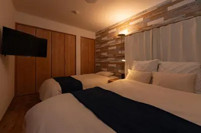 a hotel room with two beds and a flat screen tv at Shinjuku-ku - House - Vacation STAY 17230 in Tokyo