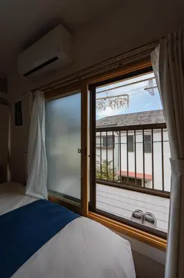 a bedroom with a bed and a large window at Shinjuku-ku - House - Vacation STAY 17230 in Tokyo
