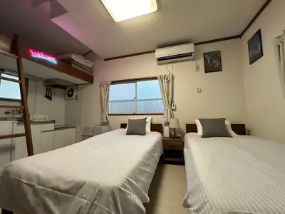 a room with two beds and a window at Kita LOVE House in Tokyo