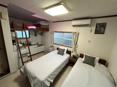 a hospital room with two beds and a window at Kita LOVE House in Tokyo
