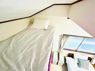 a bed in a small room with a window at Kita LOVE House in Tokyo