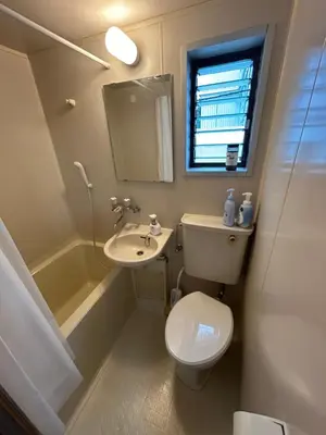 a small bathroom with a toilet and a sink at Kita LOVE House in Tokyo