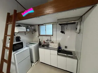 a small kitchen with a stove and a refrigerator at Kita LOVE House in Tokyo