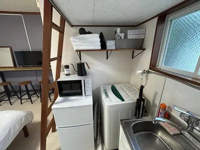 a small kitchen with a sink and a washing machine at Kita LOVE House in Tokyo