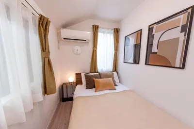 a small bedroom with a bed and a window at HOETL GOLD TOKYO - Vacation STAY 45153v in Tokyo