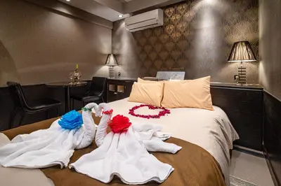 a hotel room with towels on a bed at \u30db\u30c6\u30eb\u30ea\u30aa\u30b9\u6e0b\u8c37Adults only in Tokyo