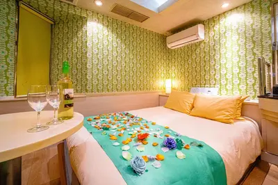 a bedroom with a bed with a bottle of wine and a table at \u30db\u30c6\u30eb\u30ea\u30aa\u30b9\u6e0b\u8c37Adults only in Tokyo