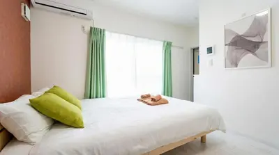 a bedroom with a bed with a teddy bear on it at #41 -Japanese-Retreat Inn- \u5800\u5207 in Tokyo