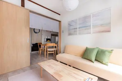 a living room with a couch and a table at SUSHI STAY tokyo in Tokyo