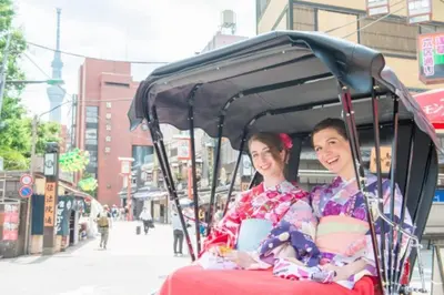 a man and a woman sitting in a golf cart at SUSHI STAY tokyo in Tokyo