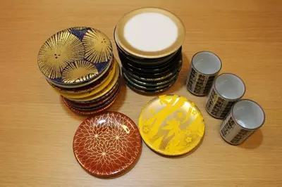 a group of plates and bowls on a table at SUSHI STAY tokyo in Tokyo