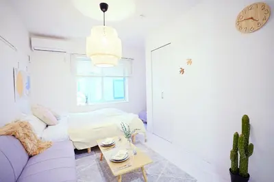 a living room with a couch and a table at Nordic-Retreat Inn in Tokyo