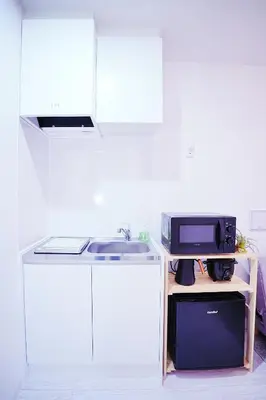a kitchen with a sink and a microwave at Nordic-Retreat Inn in Tokyo