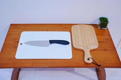 a cutting board with a knife and a spatula on a table at Nordic-Retreat Inn in Tokyo