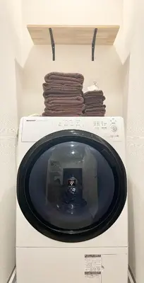 a washing machine with towels on top of it at Kita-Ueno Inn - Near UENO, ASAKUSA, SENSOJI, TOKYO SKY TREE - Self check-in in Tokyo