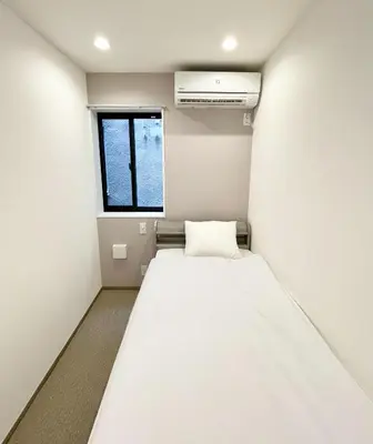 a small room with a bed and a window at Kita-Ueno Inn - Near UENO, ASAKUSA, SENSOJI, TOKYO SKY TREE - Self check-in in Tokyo