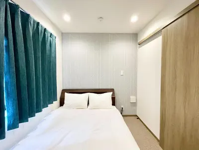 a bedroom with a bed and a large painting on the wall at Kita-Ueno Inn - Near UENO, ASAKUSA, SENSOJI, TOKYO SKY TREE - Self check-in in Tokyo
