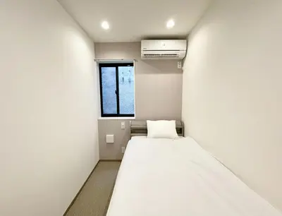a small room with a bed and a window at Kita-Ueno Inn - Near UENO, ASAKUSA, SENSOJI, TOKYO SKY TREE - Self check-in in Tokyo
