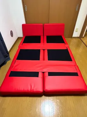 a red bed sitting on top of a wooden floor at S,F, Heights - Vacation STAY 17170 in Tokyo