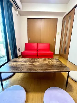 a room with a table and a red couch at S,F, Heights - Vacation STAY 17170 in Tokyo