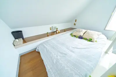 a bedroom with a large bed with white sheets and pillows at SC 206 Cozy Private Stay with Loft Near Station Free WiFi in Tokyo