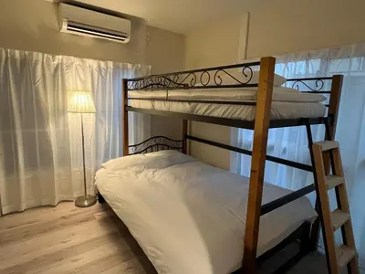 a bedroom with two bunk beds and a lamp at Cozy inn \u897f\u54c1\u5ddd101 in Tokyo