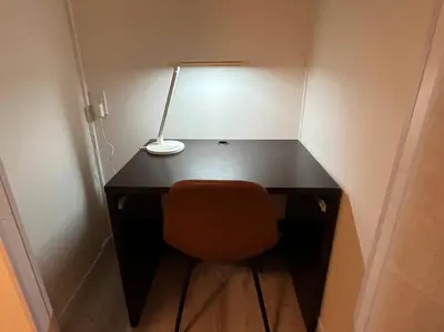 a desk with a lamp and a chair in a room at Cozy inn \u897f\u54c1\u5ddd101 in Tokyo